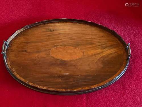 A George III satin-wood inlaid mahogany oval tea-tray with b...