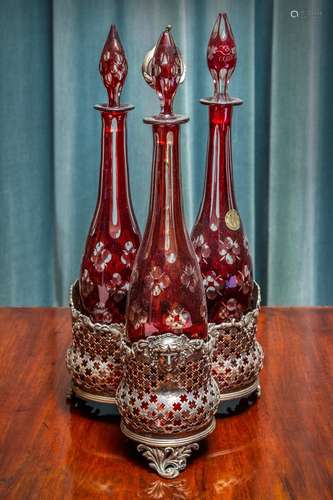 A Victorian ruby glass and silver-plated three bottle decant...