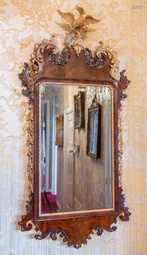 A fine George II mahogany parcel-gilt and carved wall-mirror...