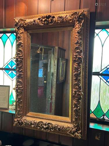 A gilt-wood floral and scroll carved wall mirror, French 19t...