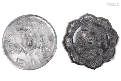 A Tang style bronze mirror, relief cast with two opposing ho...