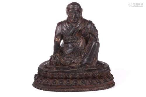 A Chinese bronze figure of a Tibetan Buddhist master, seated...