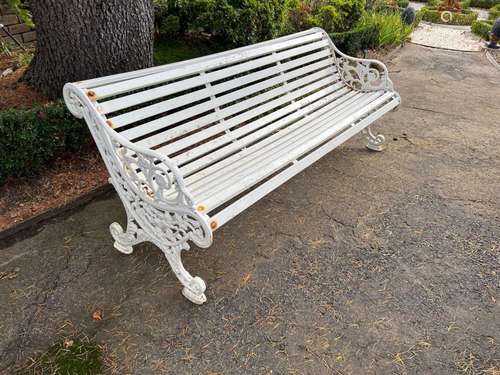 A white-painted slatted wood and cast-iron garden seat,Engli...