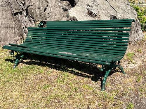 A green painted slatted wood metal garden seat 180cm wide