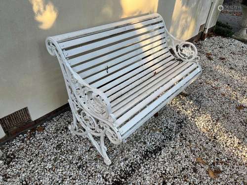 A white-painted slatted wood and cast- iron garden seat, Eng...