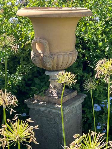 A Coade-stone type Grecian urn, on re-constituted stone pede...