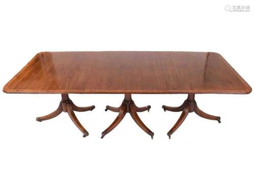 A George III style triple mahogany extending pedestal dining...