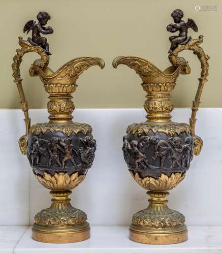 A pair of bronze and gilt-bronze ewers after the ancient Gre...