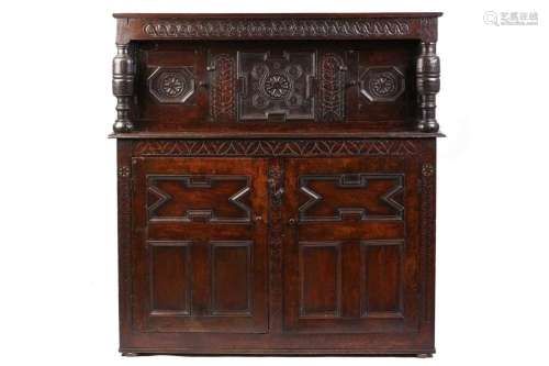 A part 17th century joined oak court cupboard, two recessed ...