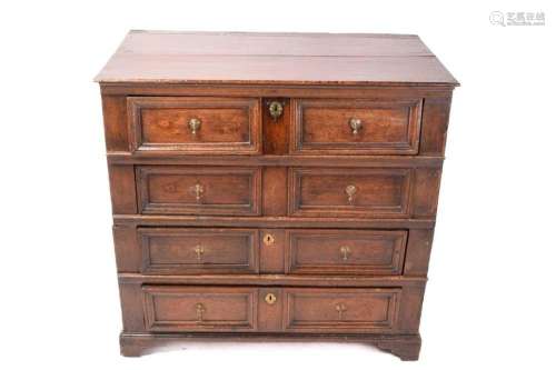 A Charles II oak two-section chest of four drawers with simp...