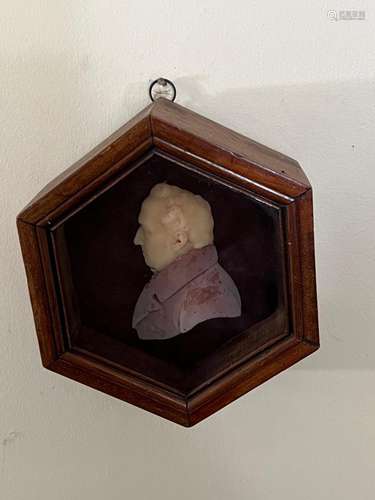 A wax profile bust of a man, in mahogany hexagonal frame,Eng...