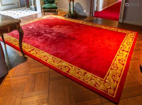 A large Empire style red ground wool-pile rug 365cm by 250cm