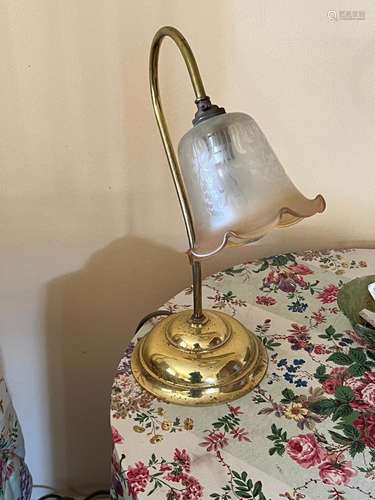 A modern brass and glass desk lamp