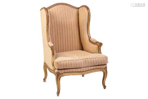 A Louis XV style bergere wing chair, 19th century, with carv...