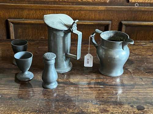 A pewter ale jug, a pewter measure with lid, two egg cups an...