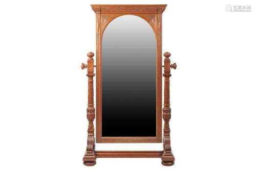 A large late Victorian carved oak cheval dressing mirror wit...