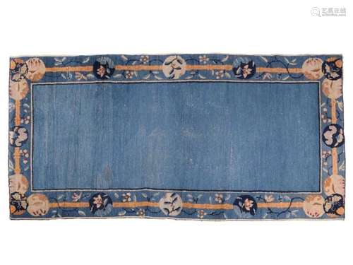 A Chinese Peking blue ground rug, late Qing, within borders ...