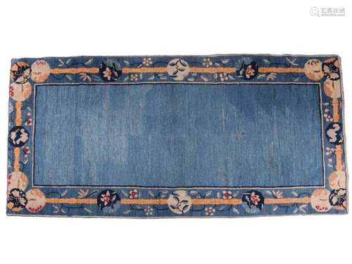 A Chinese Peking blue ground rug, late Qing, within borders ...