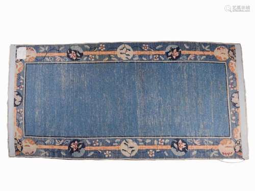 A Chinese Peking blue ground rug, late Qing, within borders ...