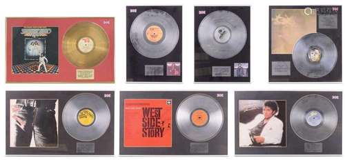 Seven framed presentation silver and gold discs, each markin...