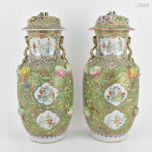 A pair of Chinese Canton Qing dynasty porcelain lidded vases...