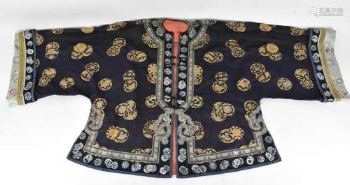 A Chinese Qing dynasty embroidered silk jacket, in navy with...