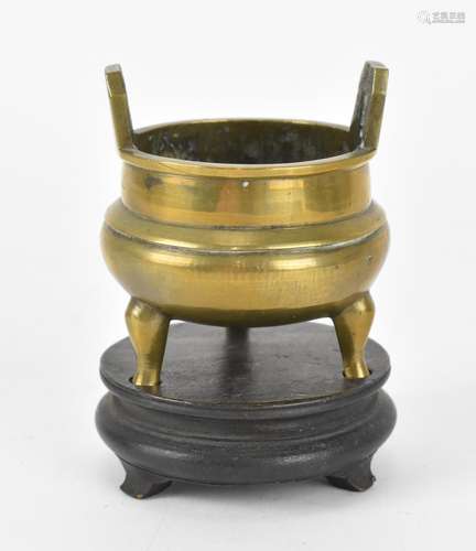 A Chinese brass tripod censor on stand, with apocryphal Xuan...