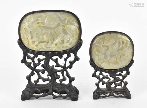 Two Chinese celadon jade plaques on stand, each with carved ...