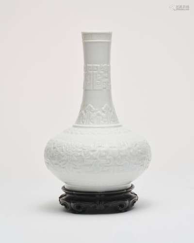 A white-glazed moulded vase Qianlong six-character impressed...