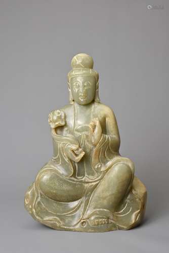 A CHINESE CELADON JADE FIGURE OF GAUNYIN. The figure seated ...