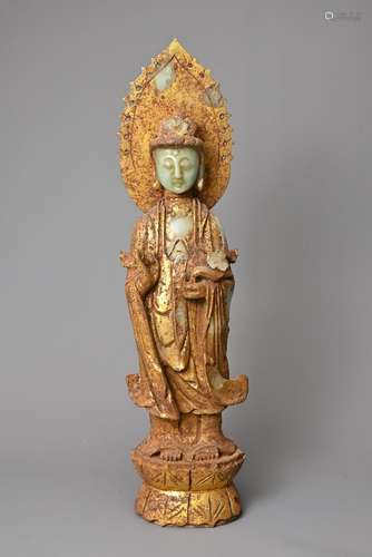 A CHINESE GILT DECORATED CELADON JADE FIGURE OF GUANYIN. The...