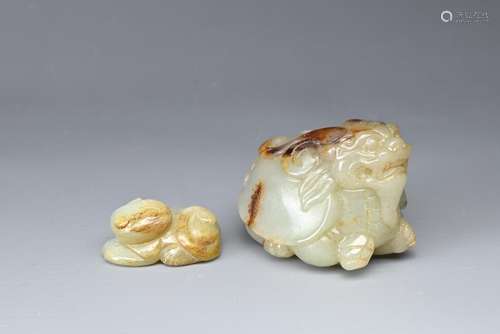 A CHINESE CARVED JADE MYTHICAL BEAST AND A CAT. The beast of...