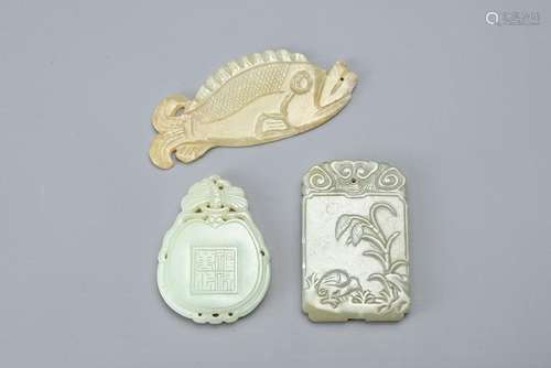 THREE CHINESE CARVED JADE PENDANTS. Comprising: a fish carve...