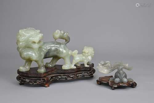 TWO CHINESE CAVRED JADE SERPENTINE FIGURES ON WOODEN STANDS,...