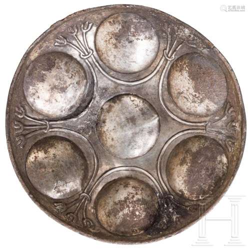 An eastern Greek silver phial with seven discs and lotus dec...