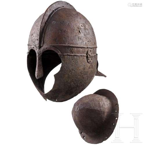 A Late Roman helmet of iron with bipartite bowl and ridge, 4...