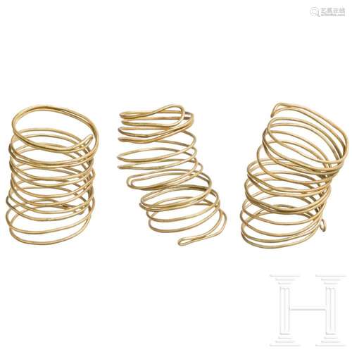 Three gold spirals made of "endless" wire, late Ur...