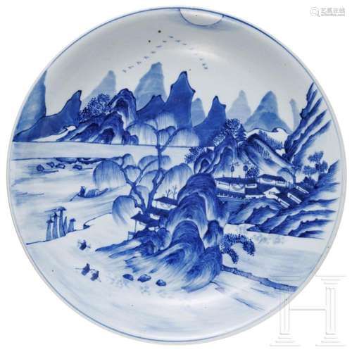 A Chinese blue and white porcelain charger with river and mo...