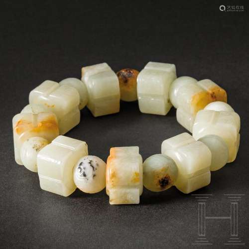 A Chinese celadon and russet jade bracelet, 20th century