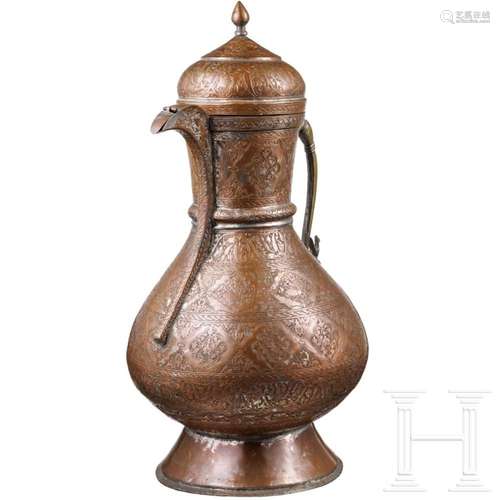 A large engraved Persian water jug made of copper, circa 190...