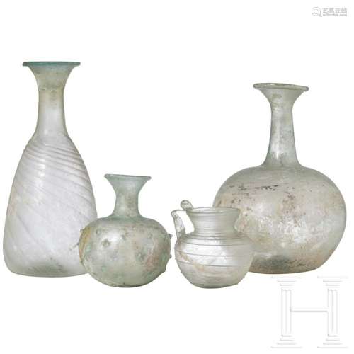 Three Roman glass vessels and one large glass bottle (later)...