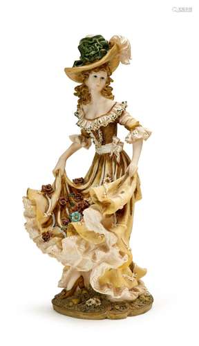 A PORCELAIN FIGURINE OF A LADY