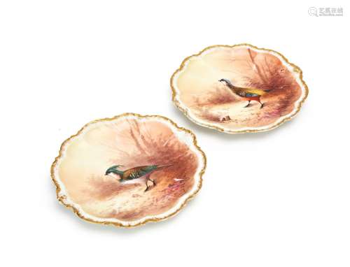 A PAIR OF PORCELAIN PEACOCK PLATES
