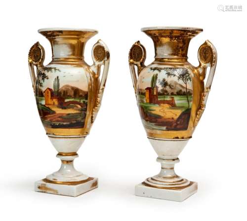 A PAIR OF NEOCLASSICAL STYLE PAINTED AND PARCEL GILT PORCELA...