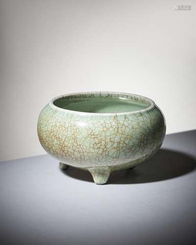 A Chinese pale celadon crackle-glazed tripod censer