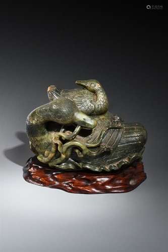 A large Chinese spinach jade \'boulder\' carving of a \'duck...