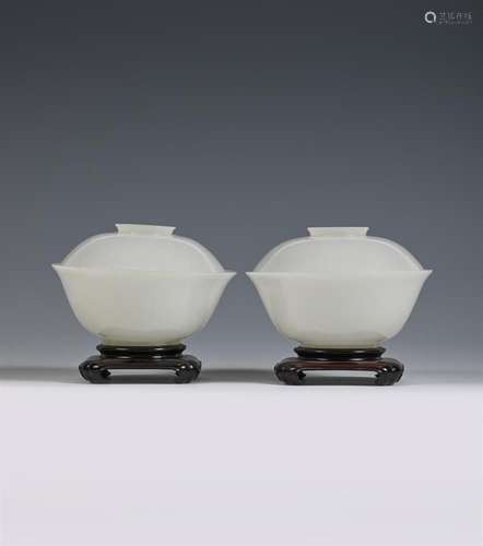 A pair of Chinese pale celadon or white jade bowls and cover...