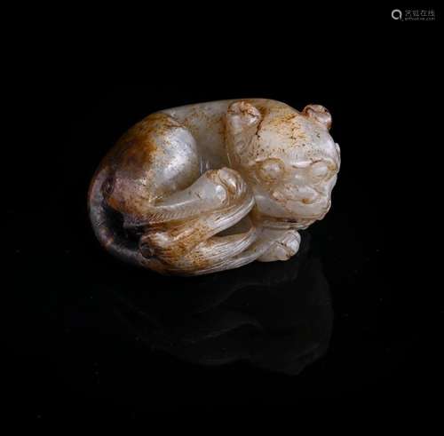 A Chinese white and russet jade lion