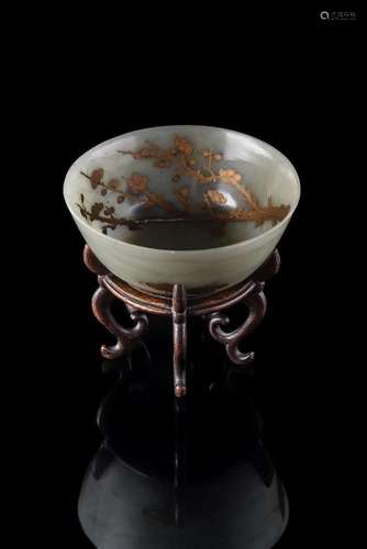 A Chinese celadon jade gilt-decorated bowl