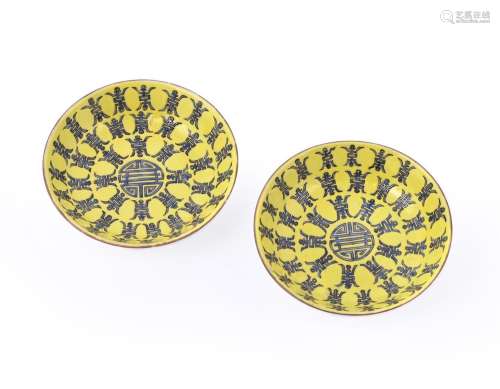 A pair of small Chinese yellow ground \'Longevity\' saucer d...